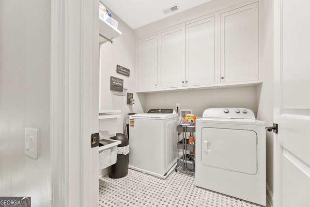 6815 Berkley Rd, Cumming, GA 30040 - laundry area featuring washer and clothes dryer, cabinet space, and light flooring
