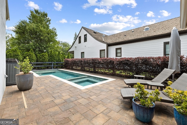6815 Berkley Rd, Cumming, GA 30040 - view of swimming pool with a patio, central air condition unit, and a pool with connected hot tub