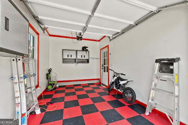 6815 Berkley Rd, Cumming, GA 30040 - garage with baseboards and a garage door opener