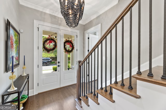 6815 Berkley Rd, Cumming, GA 30040 - foyer featuring stairs, a chandelier, wood finished floors, crown molding, and baseboards