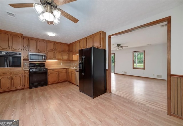 1810 King Mill Rd, Mcdonough, GA 30252 - kitchen with black appliances, ceiling fan, light wood-style flooring, and light countertops