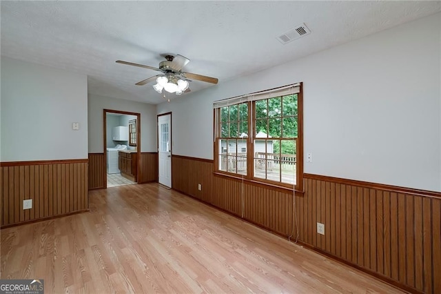 1810 King Mill Rd, Mcdonough, GA 30252 - empty room featuring wainscoting, light wood-type flooring, ceiling fan, and wood walls