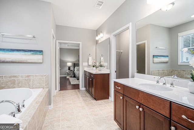1946 Jeffery Rd NW, Atlanta, GA 30318 - full bathroom featuring a garden tub, two vanities, tile patterned flooring, and baseboards