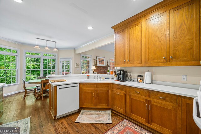 127 Chestnut Ln, Athens, GA 30606 - kitchen featuring dishwasher, brown cabinets, a peninsula, light countertops, and crown molding