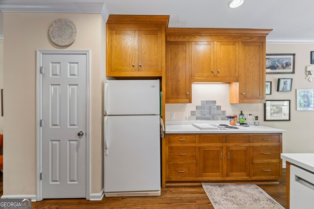 127 Chestnut Ln, Athens, GA 30606 - kitchen featuring white appliances, ornamental molding, dark wood-type flooring, brown cabinets, and light countertops