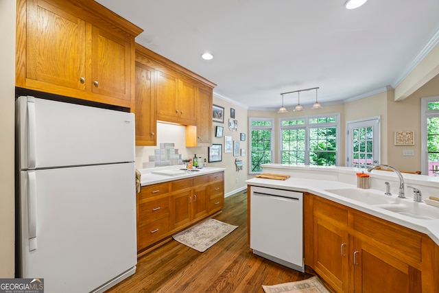 127 Chestnut Ln, Athens, GA 30606 - kitchen featuring white appliances, crown molding, brown cabinetry, dark wood-style floors, and plenty of natural light
