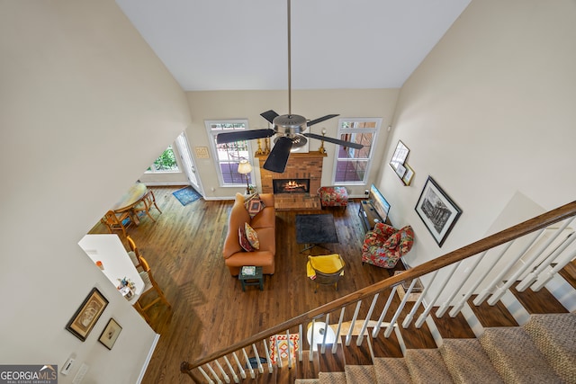 127 Chestnut Ln, Athens, GA 30606 - stairs with a ceiling fan, wood finished floors, a fireplace, and high vaulted ceiling