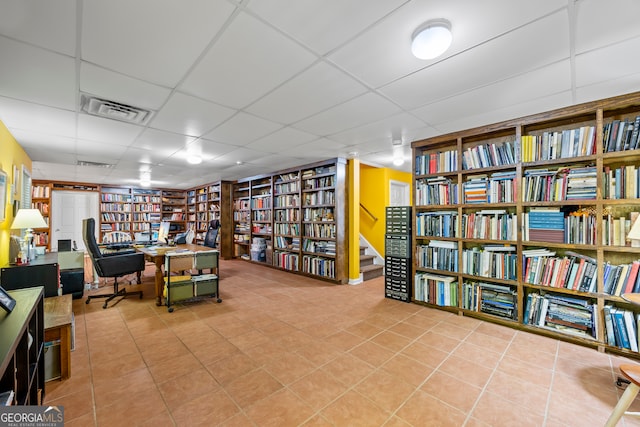 127 Chestnut Ln, Athens, GA 30606 - office area featuring wall of books, a paneled ceiling, and tile patterned floors