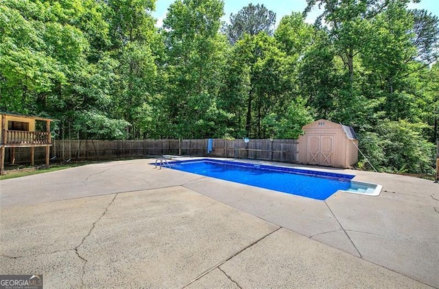 2652 Mount Tabor Church Rd, Dallas, GA 30157 - view of swimming pool featuring fence, a patio area, a storage unit, and an outbuilding