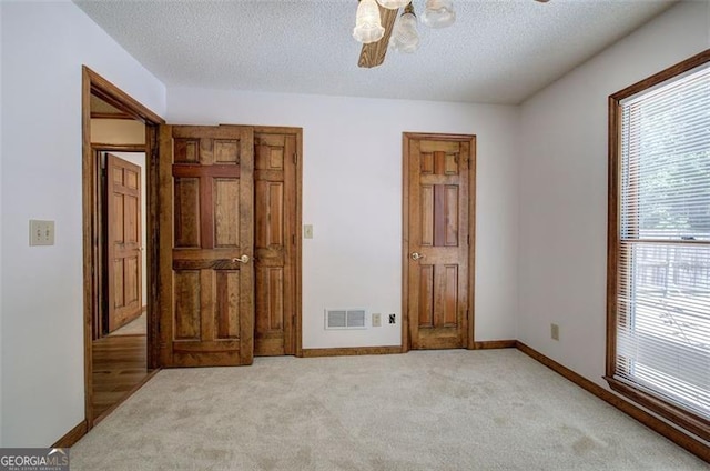 2652 Mount Tabor Church Rd, Dallas, GA 30157 - unfurnished bedroom with light colored carpet, a textured ceiling, baseboards, and ceiling fan