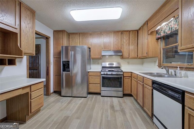 2652 Mount Tabor Church Rd, Dallas, GA 30157 - kitchen featuring appliances with stainless steel finishes, a sink, under cabinet range hood, light wood-style flooring, and a textured ceiling