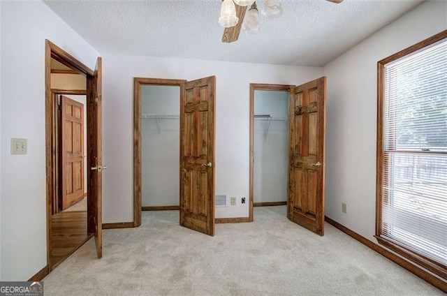 2652 Mount Tabor Church Rd, Dallas, GA 30157 - unfurnished bedroom with light colored carpet, a textured ceiling, a walk in closet, a ceiling fan, and baseboards