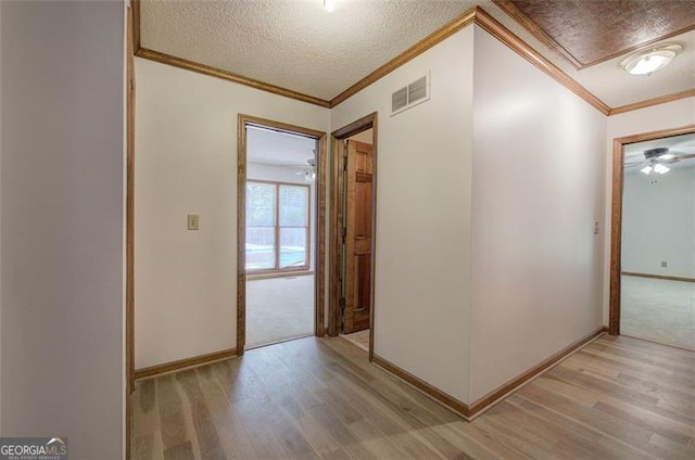 2652 Mount Tabor Church Rd, Dallas, GA 30157 - corridor featuring light wood-style floors, crown molding, a textured ceiling, baseboards, and attic access
