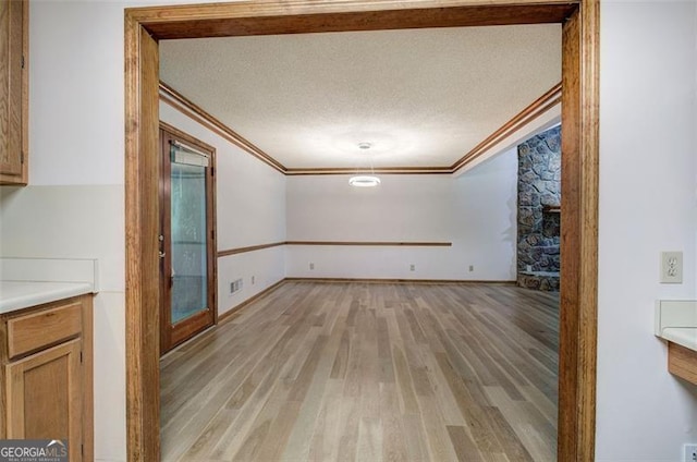 2652 Mount Tabor Church Rd, Dallas, GA 30157 - unfurnished dining area featuring ornamental molding, light wood-type flooring, and a textured ceiling