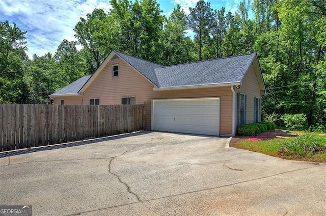 2652 Mount Tabor Church Rd, Dallas, GA 30157 - view of side of home featuring concrete driveway, an attached garage, fence, and a shingled roof
