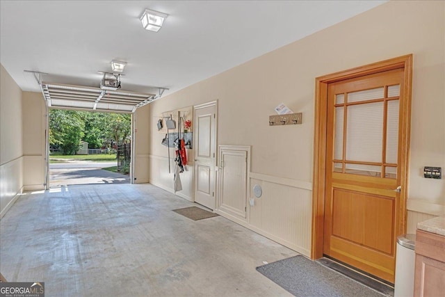 106 Arbor Ct, Dublin, GA 31021 - garage with a garage door opener, a wainscoted wall, and a decorative wall