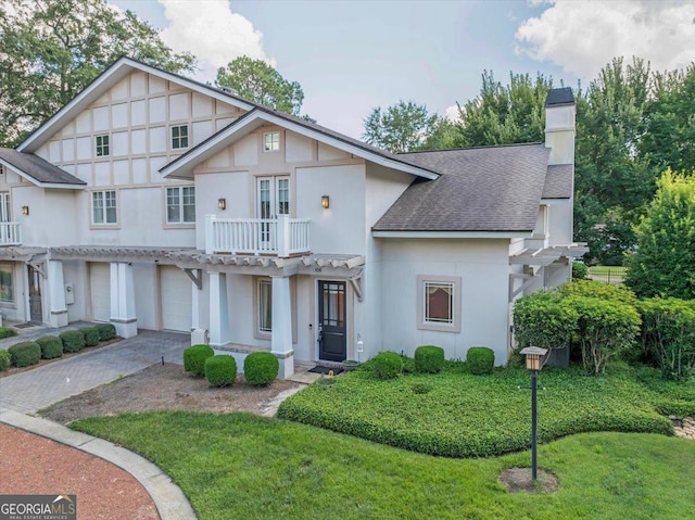 106 Arbor Ct, Dublin, GA 31021 - view of front of property featuring roof with shingles, driveway, stucco siding, an attached garage, and a chimney