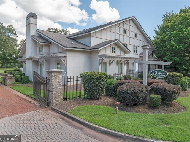 106 Arbor Ct, Dublin, GA 31021 - view of front of home featuring a chimney, a pergola, a fenced front yard, a shingled roof, and a gate