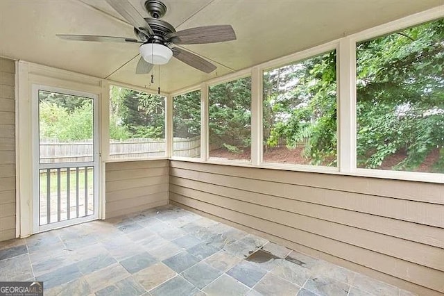unfurnished sunroom with ceiling fan