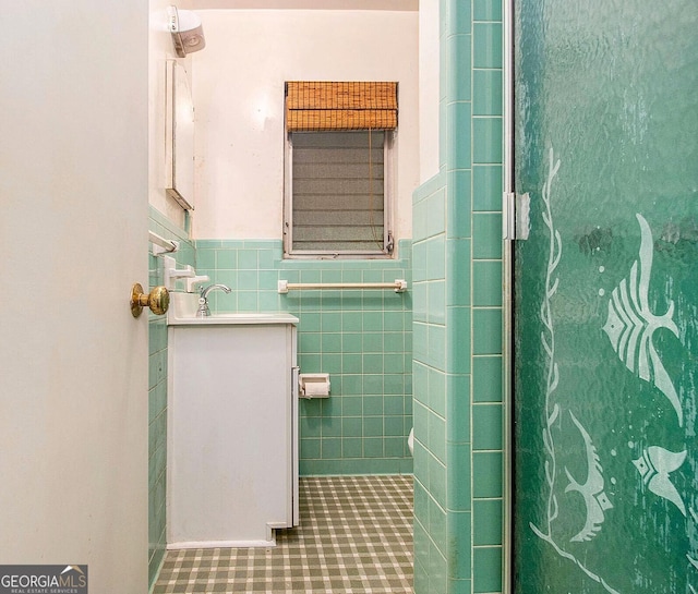894 Nottingham Dr, Avondale Estates, GA 30002 - bathroom featuring tile walls, a wainscoted wall, vanity, and tile patterned floors