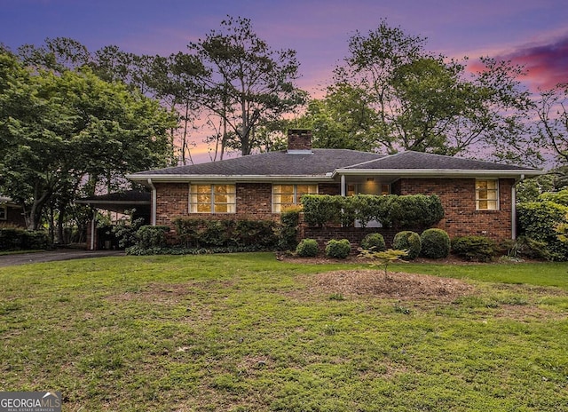 894 Nottingham Dr, Avondale Estates, GA 30002 - single story home with a chimney, brick siding, a front yard, and a carport