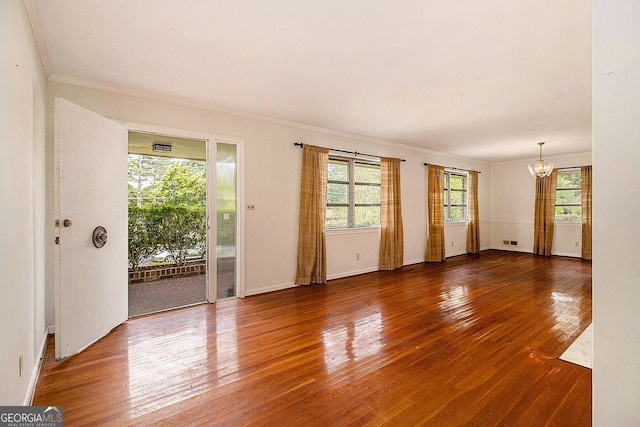 894 Nottingham Dr, Avondale Estates, GA 30002 - spare room with a chandelier, wood-type flooring, ornamental molding, and baseboards