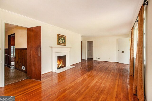 894 Nottingham Dr, Avondale Estates, GA 30002 - unfurnished living room with wood finished floors, a fireplace with flush hearth, and ornamental molding