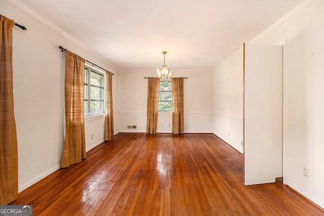 894 Nottingham Dr, Avondale Estates, GA 30002 - empty room featuring a chandelier, hardwood / wood-style flooring, ornamental molding, and baseboards