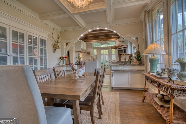 dining room with french doors, light wood-style floors, beam ceiling, coffered ceiling, and a chandelier