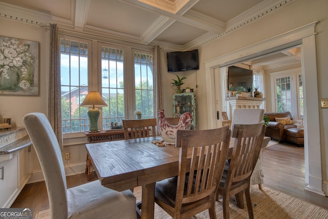 dining area with coffered ceiling, wood finished floors, beamed ceiling, and crown molding