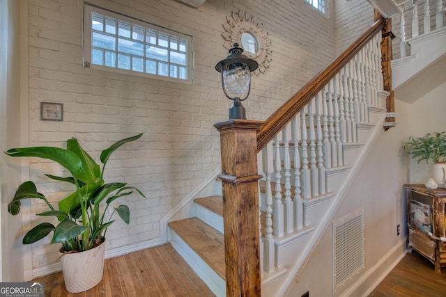 407 E 3rd St, Rome, GA 30161 - stairs with brick wall, hardwood / wood-style flooring, and baseboards