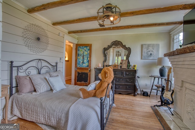 407 E 3rd St, Rome, GA 30161 - bedroom featuring beam ceiling, light wood-style floors, a brick fireplace, baseboards, and wooden walls
