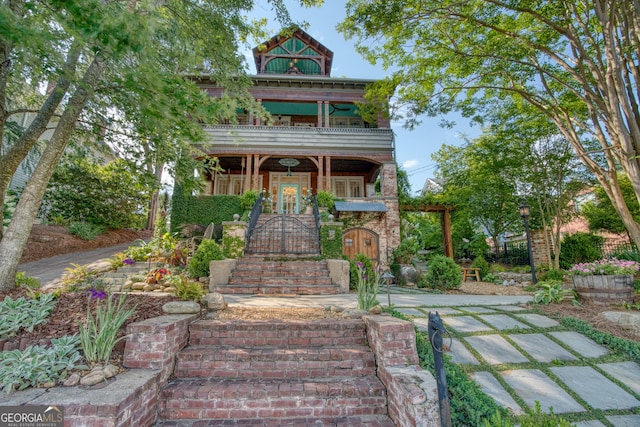 victorian-style house with a balcony and stairway