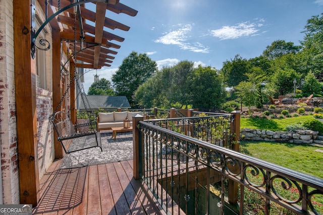 wooden terrace featuring an outdoor hangout area, a lawn, and view of wooded area