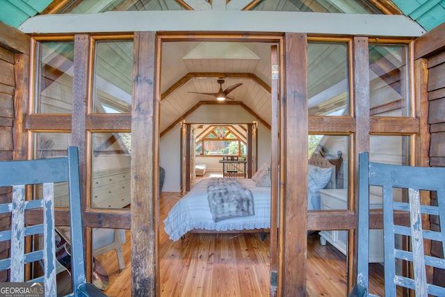 bedroom featuring lofted ceiling and wood-type flooring