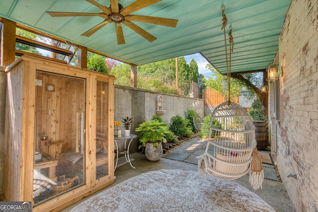 view of patio featuring a ceiling fan and fence