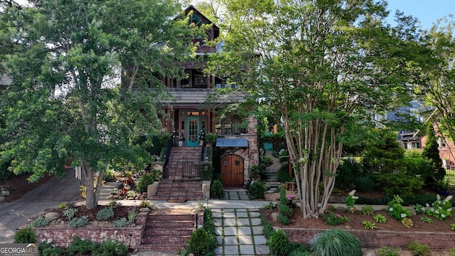 view of property hidden behind natural elements featuring stairs