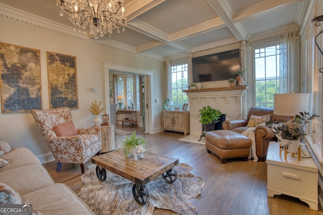 living area with ornamental molding, plenty of natural light, a chandelier, wood-type flooring, and coffered ceiling