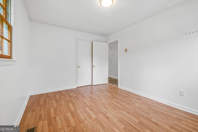 unfurnished bedroom featuring light wood-style floors and baseboards