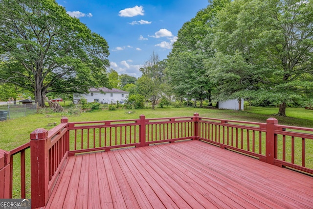 wooden terrace with a shed and an outdoor structure