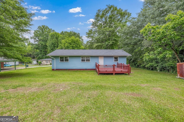 back of property featuring a wooden deck, a lawn, and crawl space