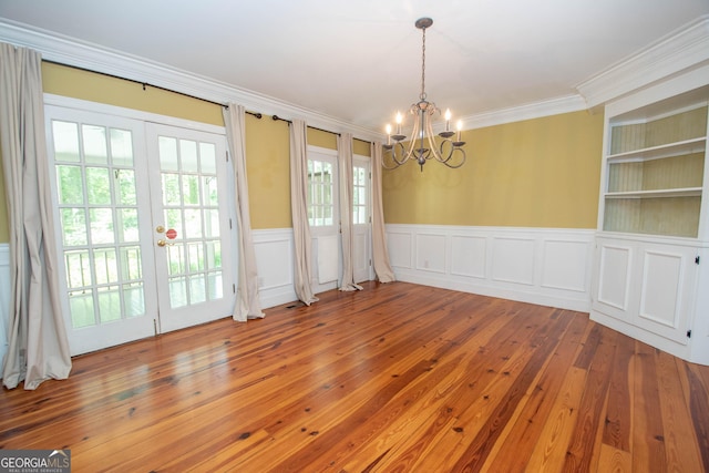 24 Overbrook Ct, Newnan, GA 30263 - unfurnished dining area with a chandelier, crown molding, wainscoting, hardwood / wood-style floors, and french doors