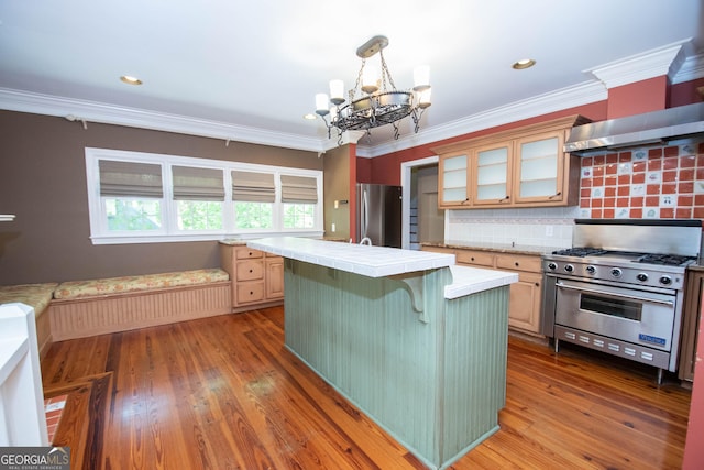 24 Overbrook Ct, Newnan, GA 30263 - kitchen with appliances with stainless steel finishes, tile counters, a chandelier, a breakfast bar area, and glass insert cabinets