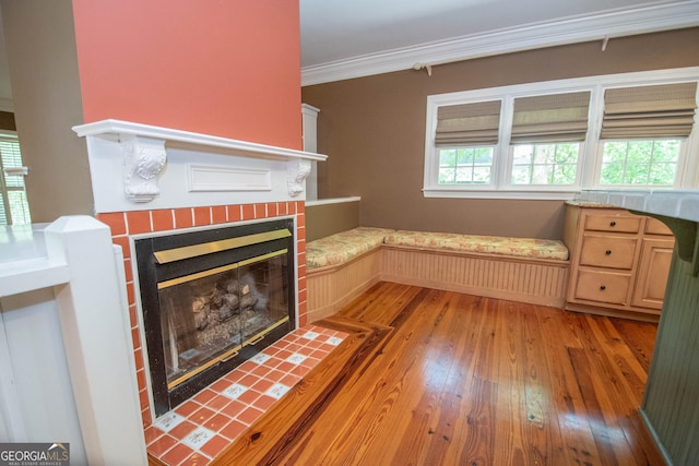 24 Overbrook Ct, Newnan, GA 30263 - living area with light wood-style flooring, crown molding, and a tile fireplace