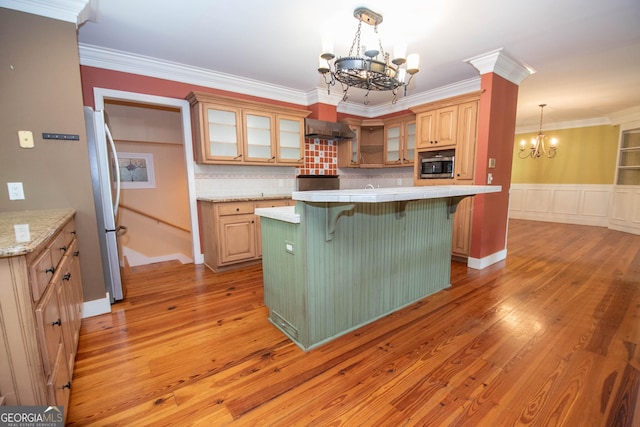 24 Overbrook Ct, Newnan, GA 30263 - kitchen with a chandelier, stainless steel appliances, wall chimney exhaust hood, light countertops, and light wood-type flooring