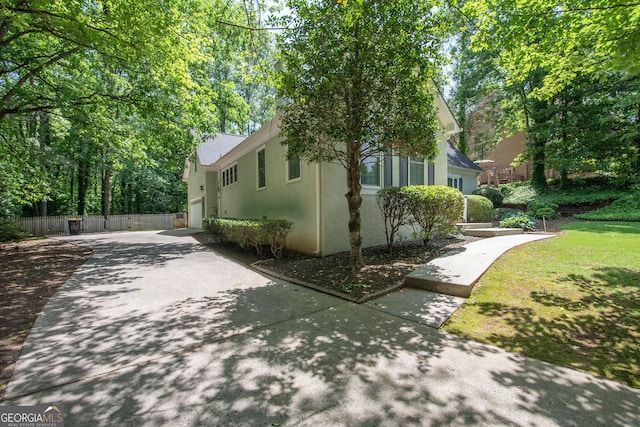 24 Overbrook Ct, Newnan, GA 30263 - view of side of property with driveway, stucco siding, fence, and a garage