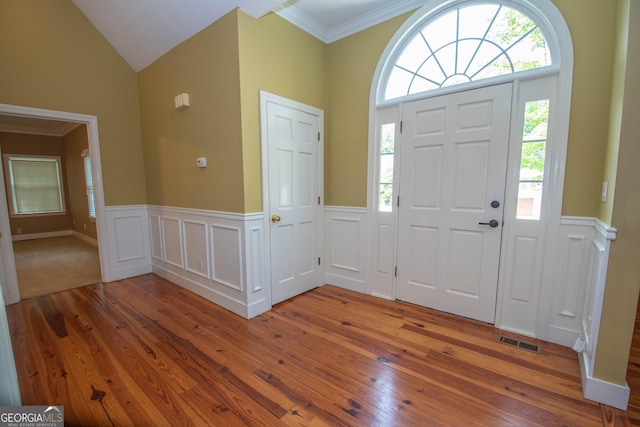 24 Overbrook Ct, Newnan, GA 30263 - foyer entrance with light wood-style floors, wainscoting, lofted ceiling, and ornamental molding