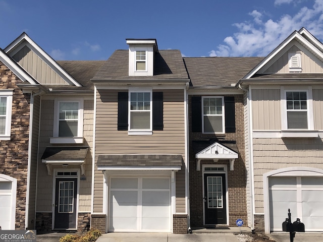 1938 Dilcrest Dr, Duluth, GA 30096 - multi unit property with stone siding, an attached garage, board and batten siding, and concrete driveway