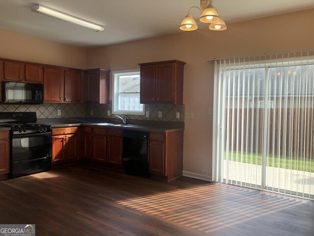 1938 Dilcrest Dr, Duluth, GA 30096 - kitchen featuring black appliances, dark countertops, dark wood-style floors, and tasteful backsplash