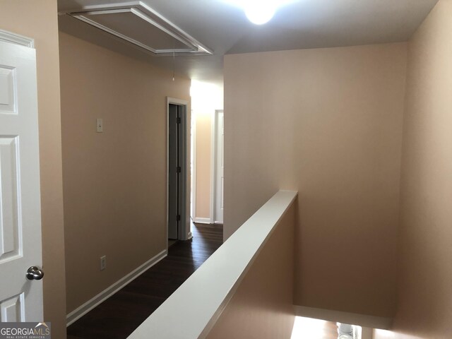 1938 Dilcrest Dr, Duluth, GA 30096 - corridor featuring attic access, dark wood finished floors, baseboards, and an upstairs landing